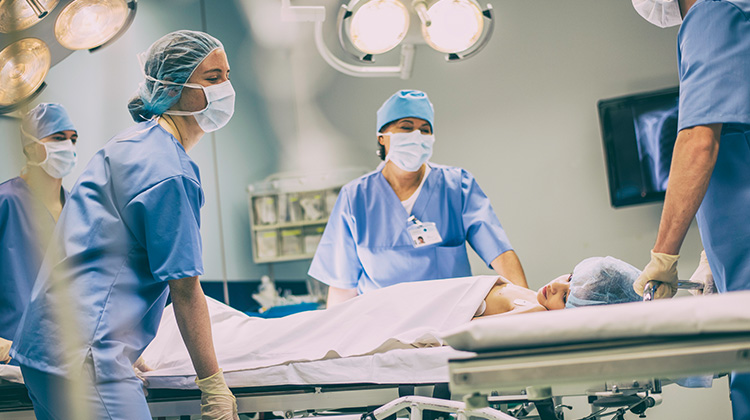 critical care doctors wheeling a patient to ER.