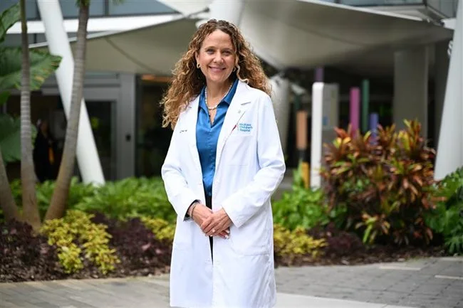 shannon in her crisp white labcoat on hospital grounds.