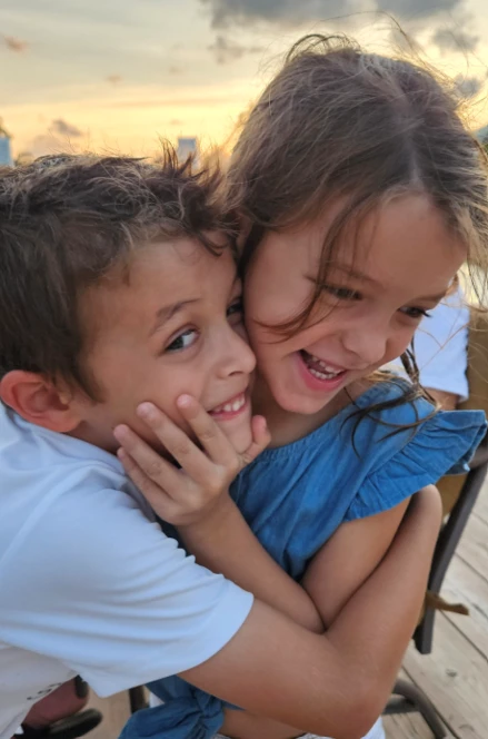 Emma hugging a her brother