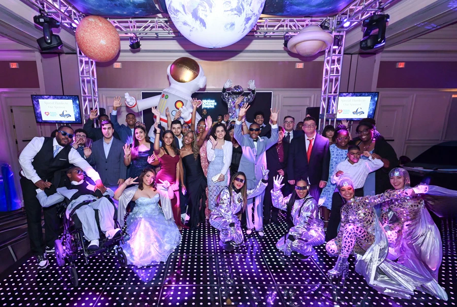 group of teen patients, parents and performers on the dancefloor.
