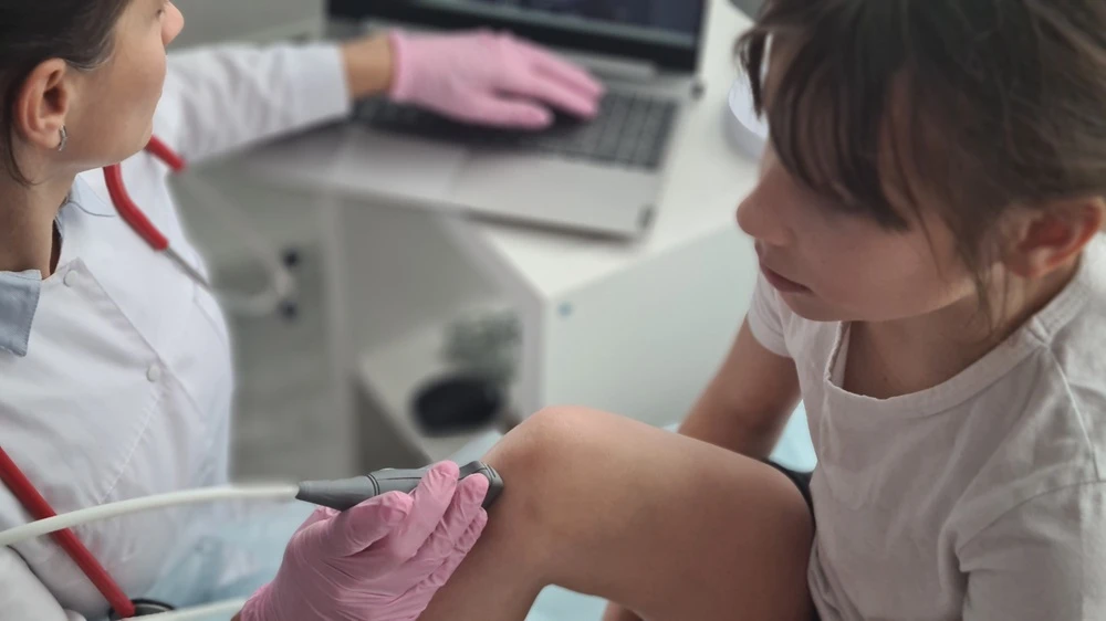 Girl getting knee ultrasound.