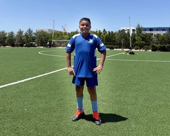 ignacio smiling on a summer soccer field.