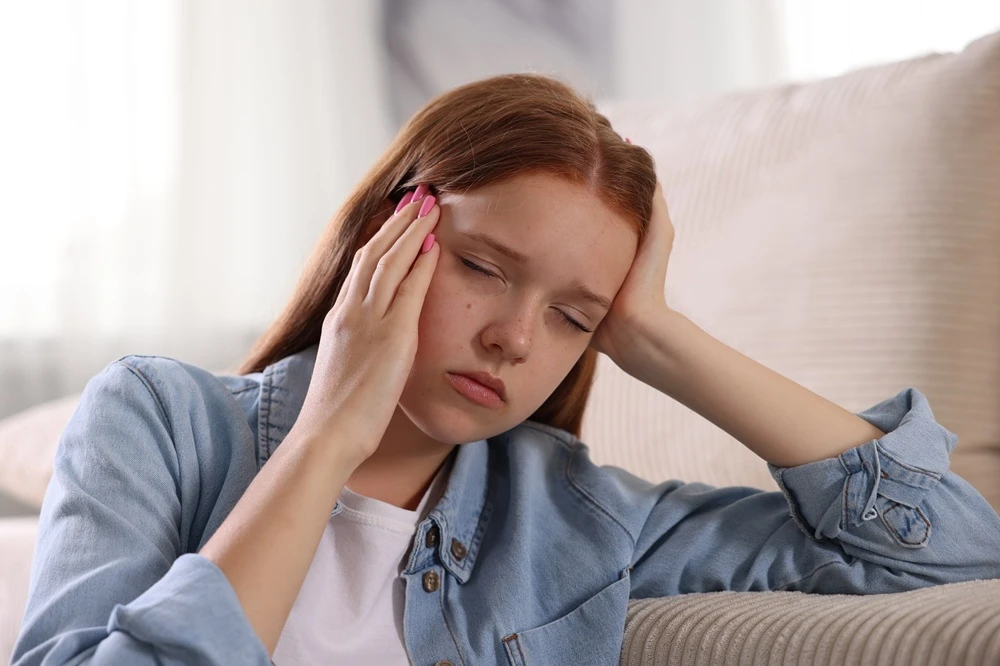 Girl in pain with migraine headache.