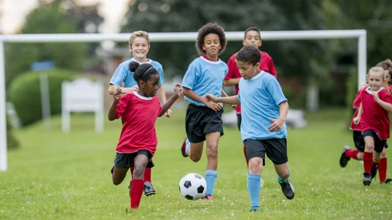 group of kids playing soccer.