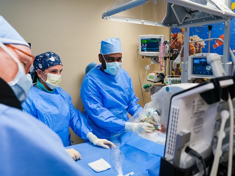 Dr. Sathanandam performing bedside PDA closure with team.